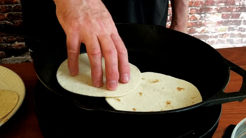 3 flour tortillas on the griddle for shrimp tacos