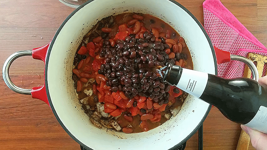 adding beans and root beer to the chili