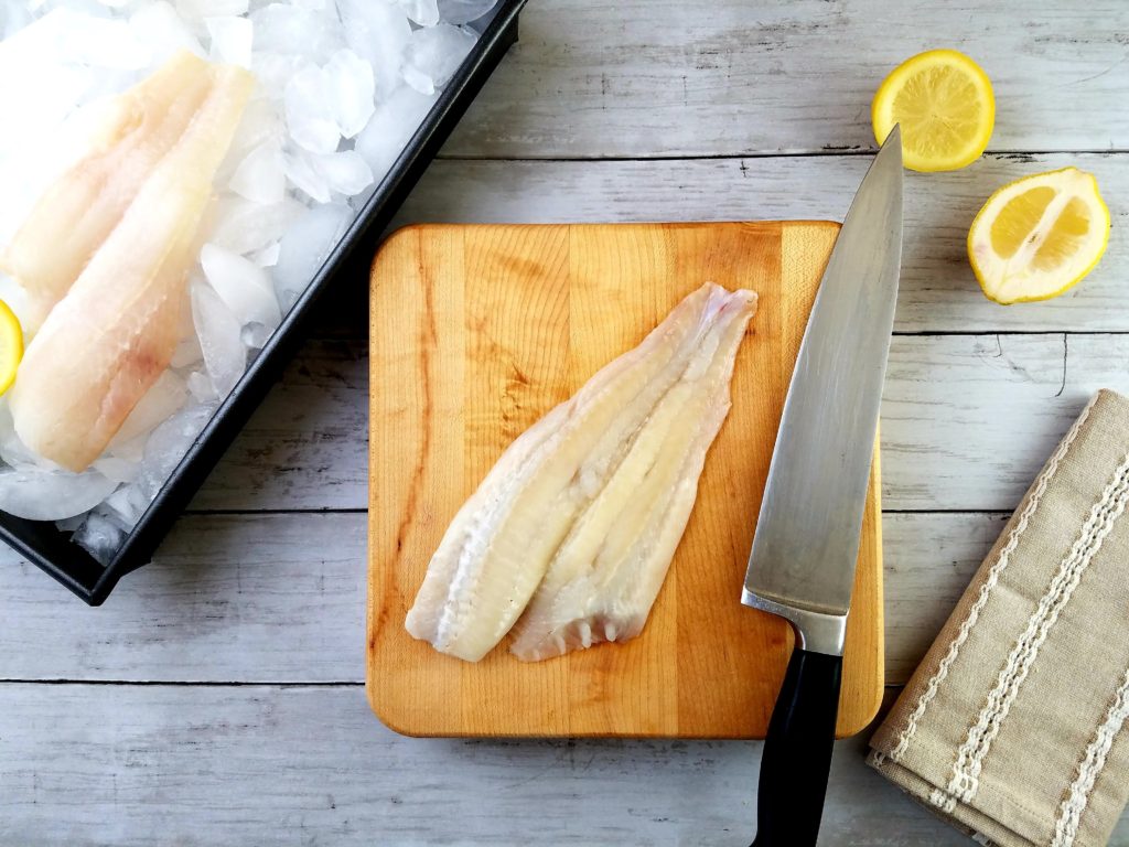 raw flounder fillets on ice