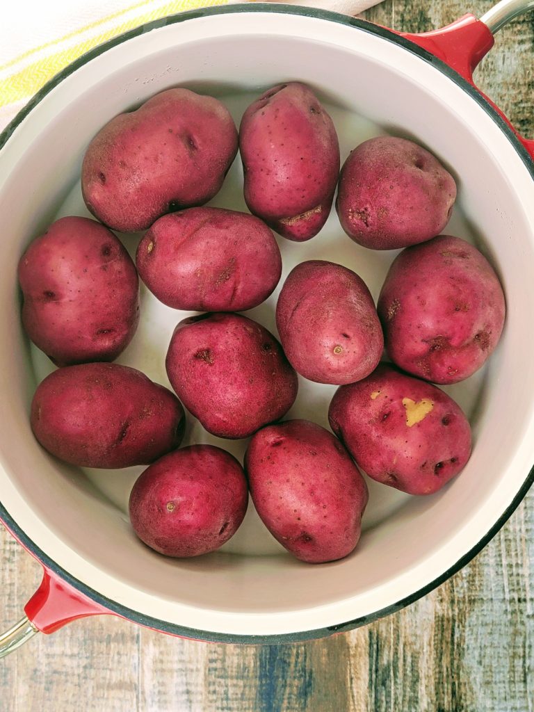 red potatoes in pot of water